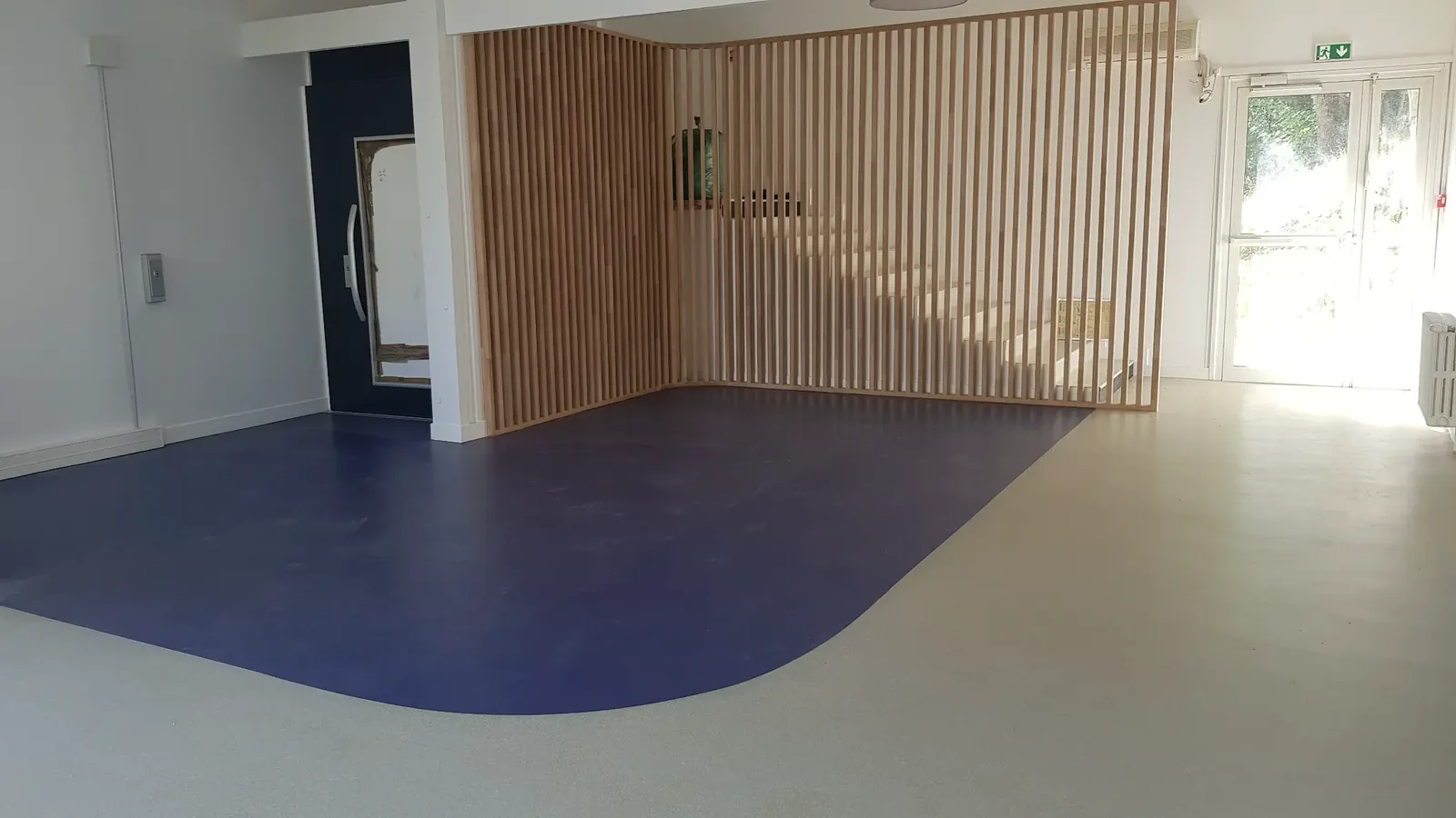 Sol en résine bleu et gris dans un espace d’accueil